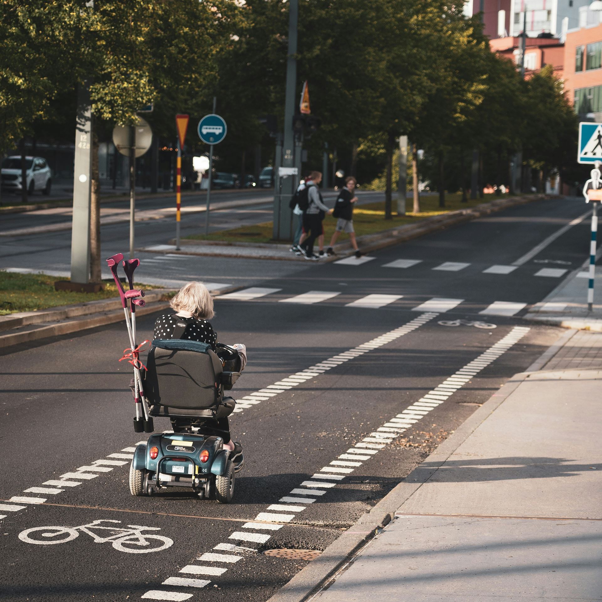 person in wheelchair on road